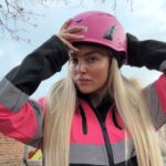 Pink hard hat videographer Abbey Moring defies critics filming scaffolding sites at height turning a mans world into viral marketing success for her boyfriends business .