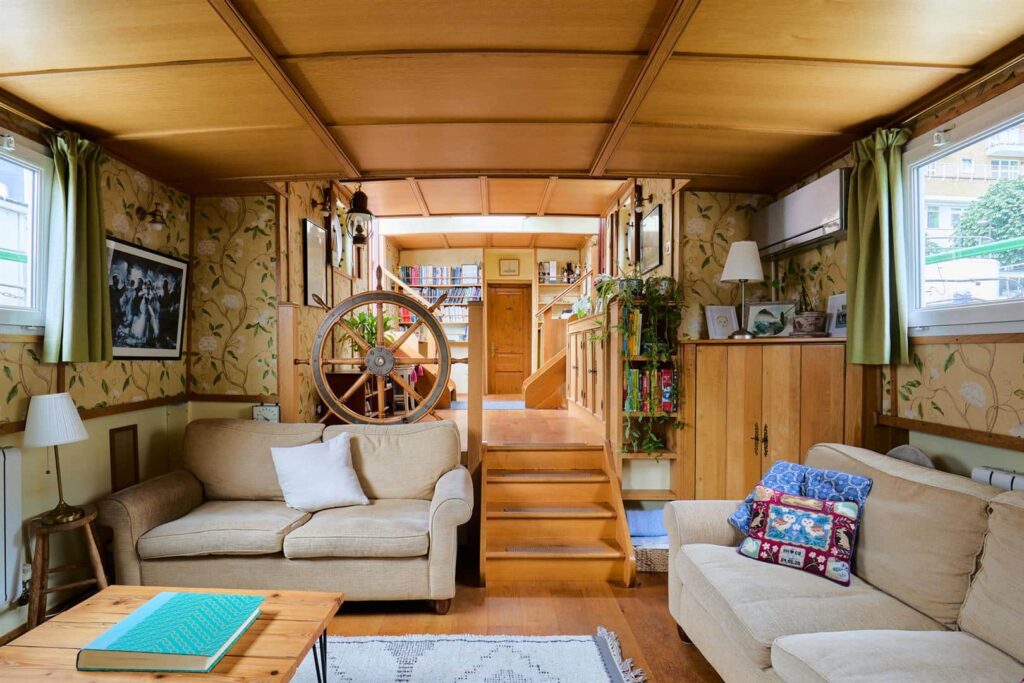 Floating hotel barge on Thames hits market for £1m. 1926 Dutch vessel with three bedrooms, panoramic river views and rare 105-year Battersea mooring lease included.