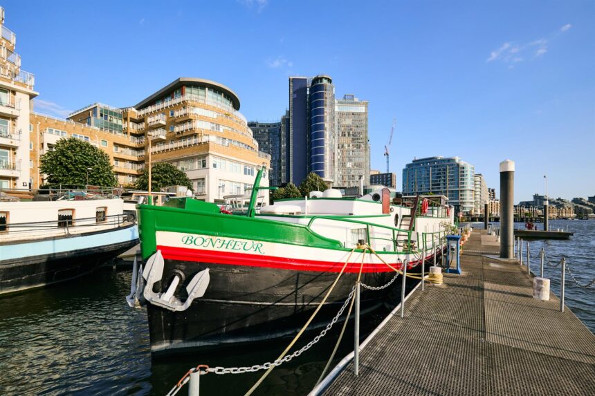Floating hotel barge on Thames hits market for £1m. 1926 Dutch vessel with three bedrooms, panoramic river views and rare 105-year Battersea mooring lease included.