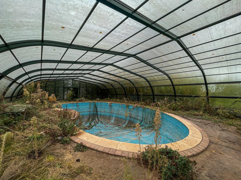 Urban explorer discovers £1.4m abandoned mansion in Gloucester with swimming pool, snooker table - renovation halted mid-project, now decaying deep in overgrown woodland.