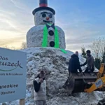 Couple builds Lars the Great, a 100-ton 38ft snowman at German mountain campsite with help from 30 volunteers. The giant features hand-crocheted scarf.