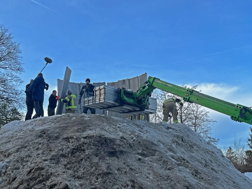 Couple builds Lars the Great, a 100-ton 38ft snowman at German mountain campsite with help from 30 volunteers. The giant features hand-crocheted scarf.
