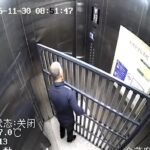 CCTV captures an elderly man stuck in a lift with a bulky bed frame, trapped for 14 minutes as doors jam shut in a slapstick mishap that sent viewers laughing online now