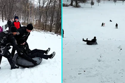 Police officer launched down snowy hill in rubber ring goes viral after hitting bump and crashing onto his back - 89,000 likes as viewers joke about service weapon.