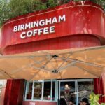 British backpackers discover Birmingham Coffee cafe in Nha Trang, Vietnam, 6,000 miles away, featuring Peaky Blinders art and Bull Ring pictures with cheap lattes.