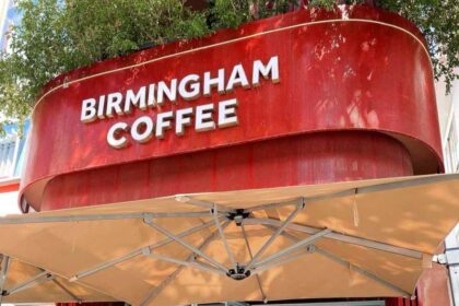 British backpackers discover Birmingham Coffee cafe in Nha Trang, Vietnam, 6,000 miles away, featuring Peaky Blinders art and Bull Ring pictures with cheap lattes.