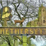 Lorry driver spends six weeks hand-restoring 50-year-old Hethersett village sign near Norwich. Self-taught Craig Jenkins saved the rotten oak carving for locals.