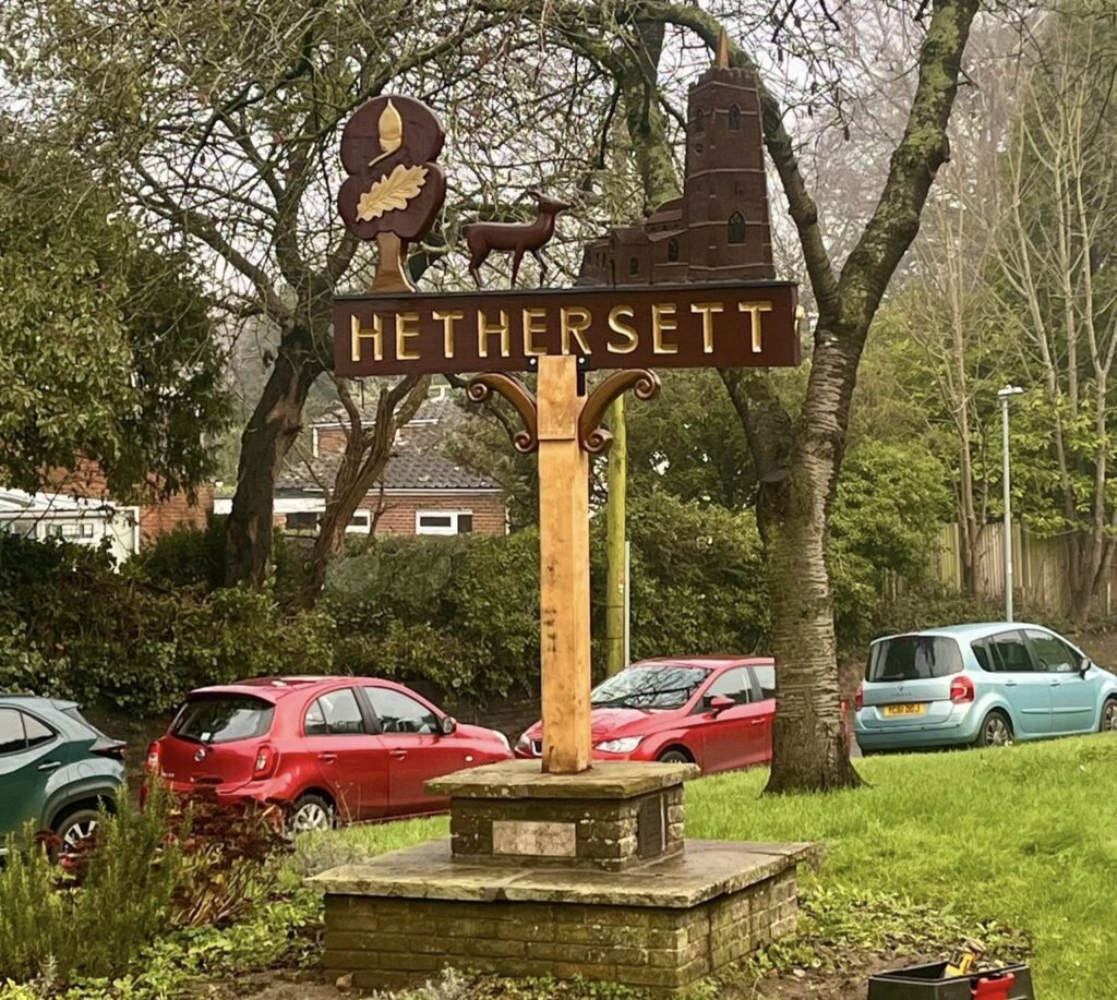 Lorry driver spends six weeks hand-restoring 50-year-old Hethersett village sign near Norwich. Self-taught Craig Jenkins saved the rotten oak carving for locals.
