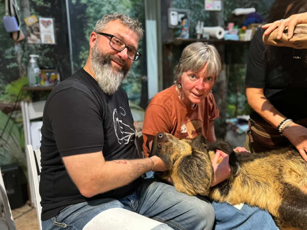 Woman with terminal MSA blows toy horn using neck tracheotomy in heartwarming viral video. Andrea Brown spreads joy with brother on FaceTime despite her diagnosis.