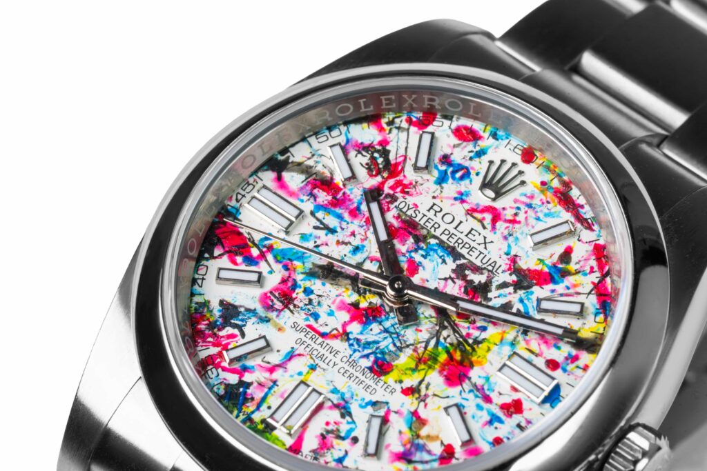 An artist turned a Rolex into abstract art by letting paint covered flies splatter the watch face, creating a one of a kind piece that stunned millions online.