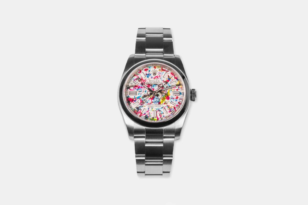 An artist turned a Rolex into abstract art by letting paint covered flies splatter the watch face, creating a one of a kind piece that stunned millions online.
