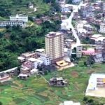 Zhou family built 15-storey skyscraper in rural China to house over 100 relatives across four generations. The decade-old tower has 22 apartments and sticks out from village.