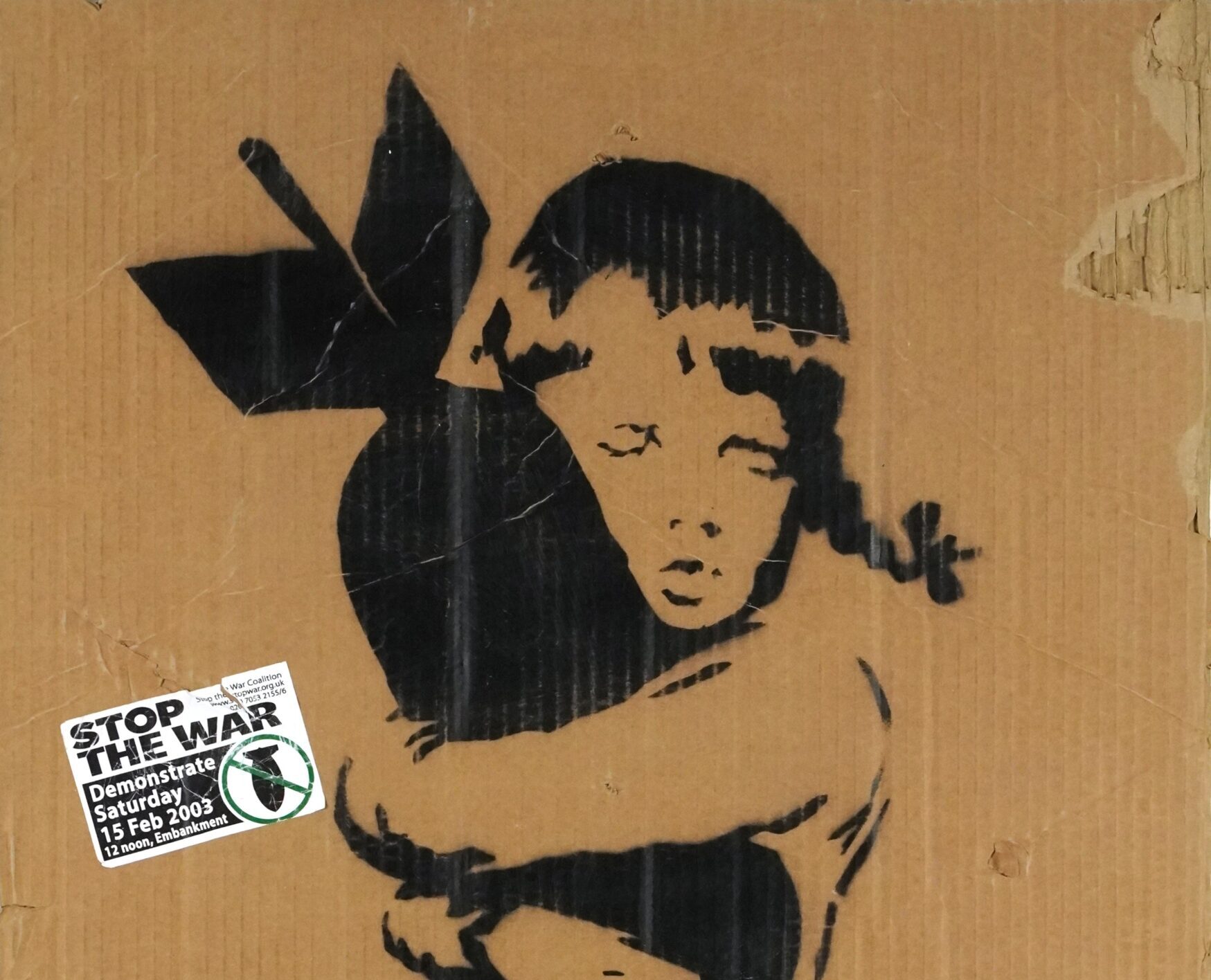 Early Banksy anti Iraq War placards Bomb Hugger and Yellow Chopper have sold for £1,800 each, rare relics from the 2003 London protest march.