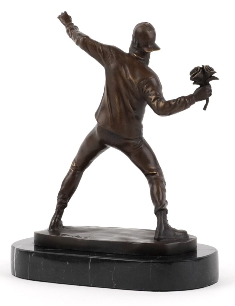 Early Banksy anti Iraq War placards Bomb Hugger and Yellow Chopper have sold for £1,800 each, rare relics from the 2003 London protest march.