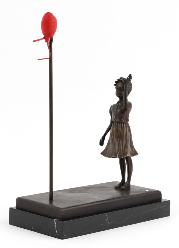 Early Banksy anti Iraq War placards Bomb Hugger and Yellow Chopper have sold for £1,800 each, rare relics from the 2003 London protest march.