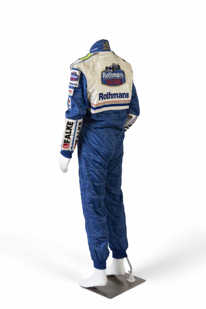 A signed Ferrari racing suit worn by Michael Schumacher at his 2006 Italian Grand Prix win has sold for nearly £100,000, smashing estimates at auction.