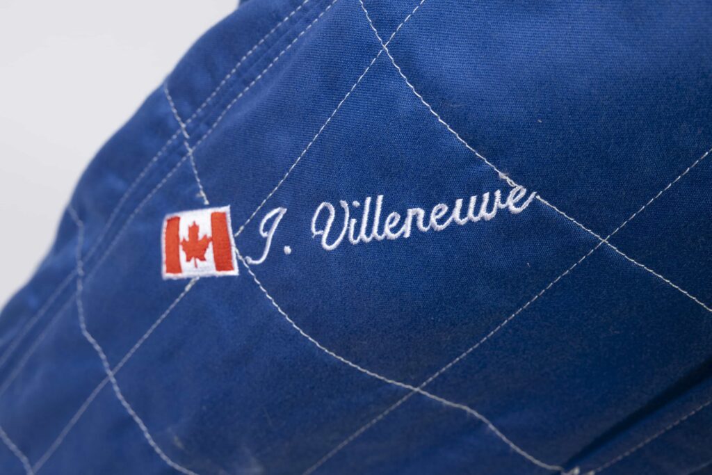 A signed Ferrari racing suit worn by Michael Schumacher at his 2006 Italian Grand Prix win has sold for nearly £100,000, smashing estimates at auction.