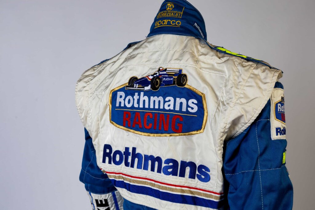 A signed Ferrari racing suit worn by Michael Schumacher at his 2006 Italian Grand Prix win has sold for nearly £100,000, smashing estimates at auction.