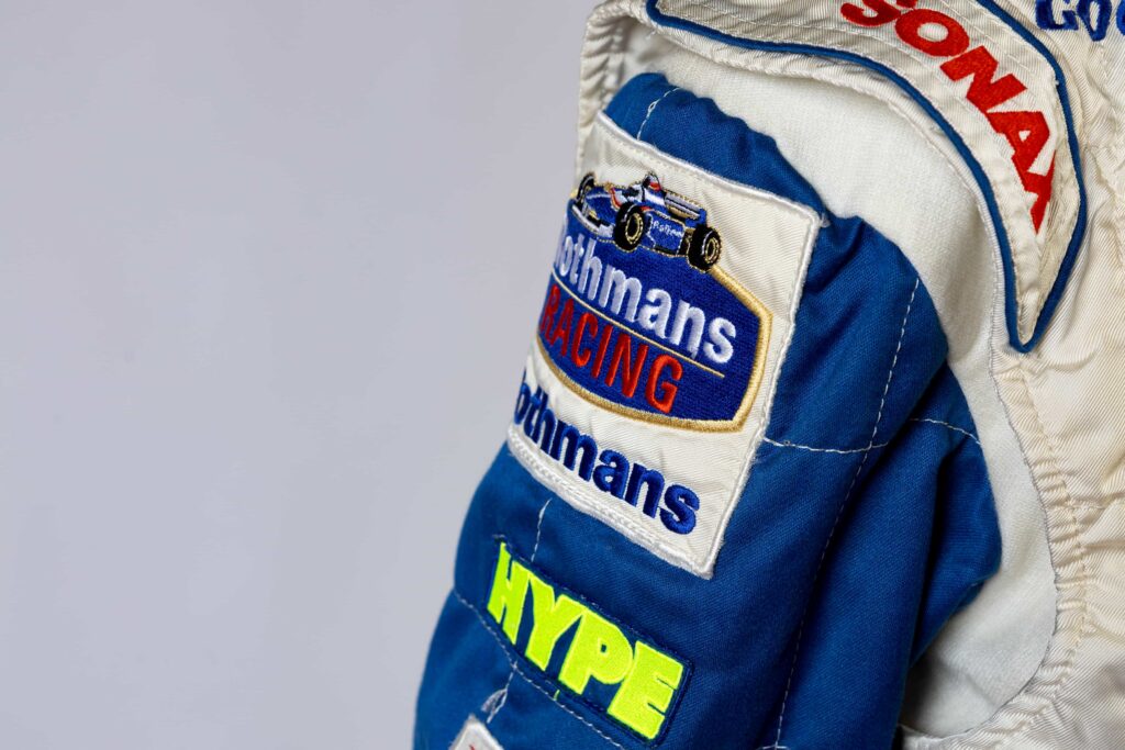 A signed Ferrari racing suit worn by Michael Schumacher at his 2006 Italian Grand Prix win has sold for nearly £100,000, smashing estimates at auction.