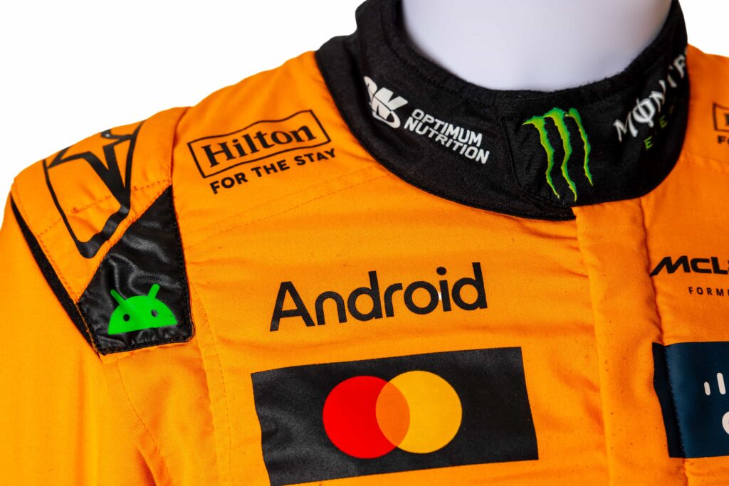 A signed Ferrari racing suit worn by Michael Schumacher at his 2006 Italian Grand Prix win has sold for nearly £100,000, smashing estimates at auction.