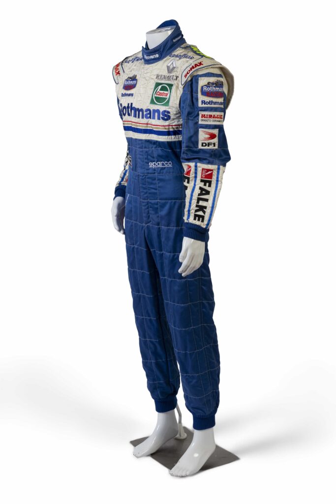 A signed Ferrari racing suit worn by Michael Schumacher at his 2006 Italian Grand Prix win has sold for nearly £100,000, smashing estimates at auction.