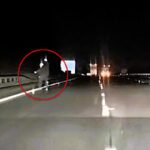 Singer Lauren Amour captures spooky Slenderman-like figure on dashcam while driving A69 at 2am. Tall being with glowing head moved towards her car. Over 240,000 views.
