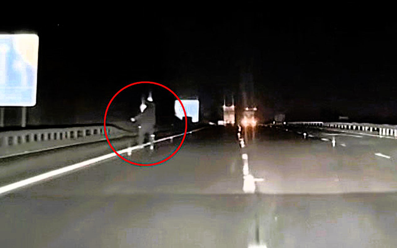 Singer Lauren Amour captures spooky Slenderman-like figure on dashcam while driving A69 at 2am. Tall being with glowing head moved towards her car. Over 240,000 views.