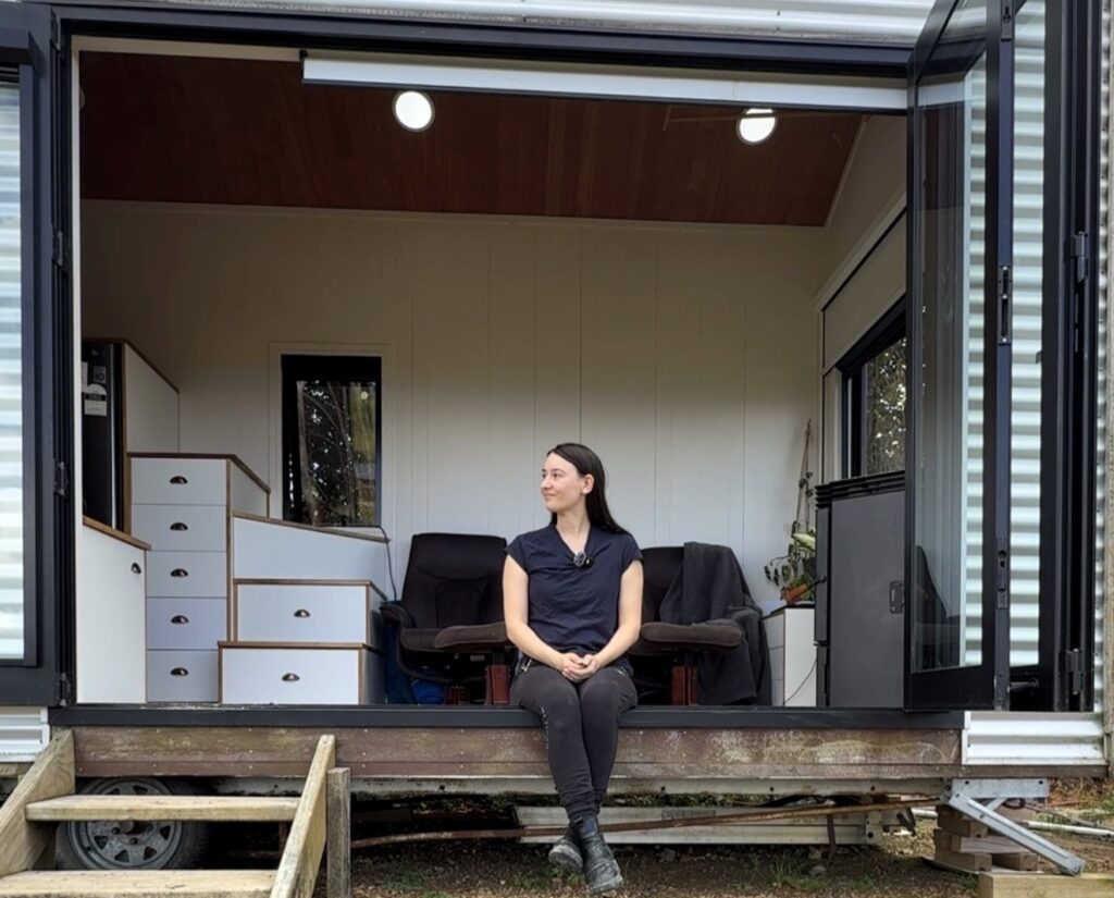 Woman saves £70,000 on bills living in 194 sq ft tiny home for 9 years in New Zealand. Features composting toilet and million-dollar view. Says she made right choice.