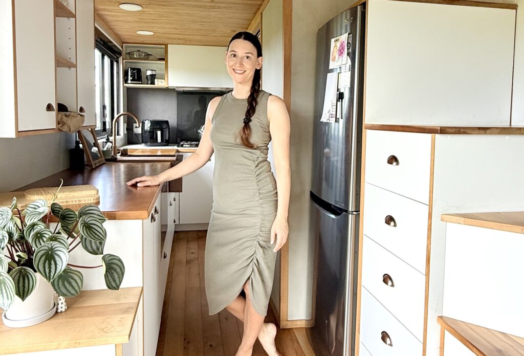 Woman saves £70,000 on bills living in 194 sq ft tiny home for 9 years in New Zealand. Features composting toilet and million-dollar view. Says she made right choice.