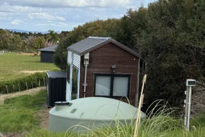 Woman saves £70,000 on bills living in 194 sq ft tiny home for 9 years in New Zealand. Features composting toilet and million-dollar view. Says she made right choice.