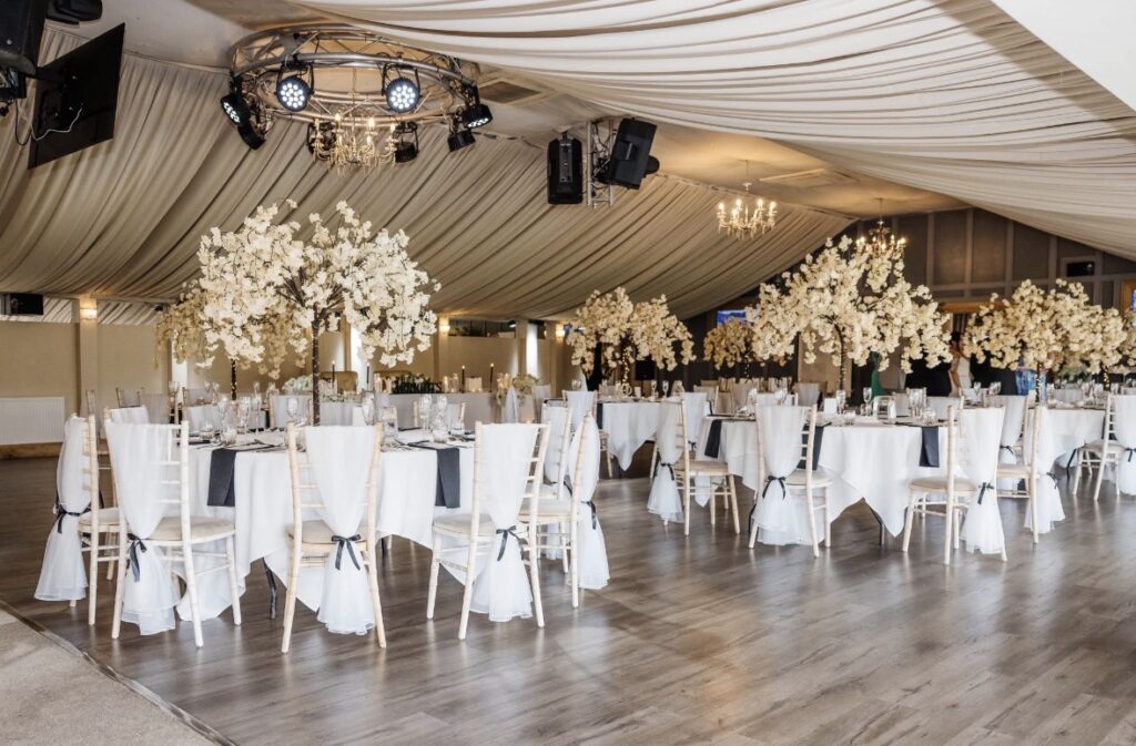 A savvy bride saved £6,000 on her dream black-and-white wedding by ditching pricey suppliers and turning to Temu - even DIYing her own flower arch for £300 instead of paying £800.