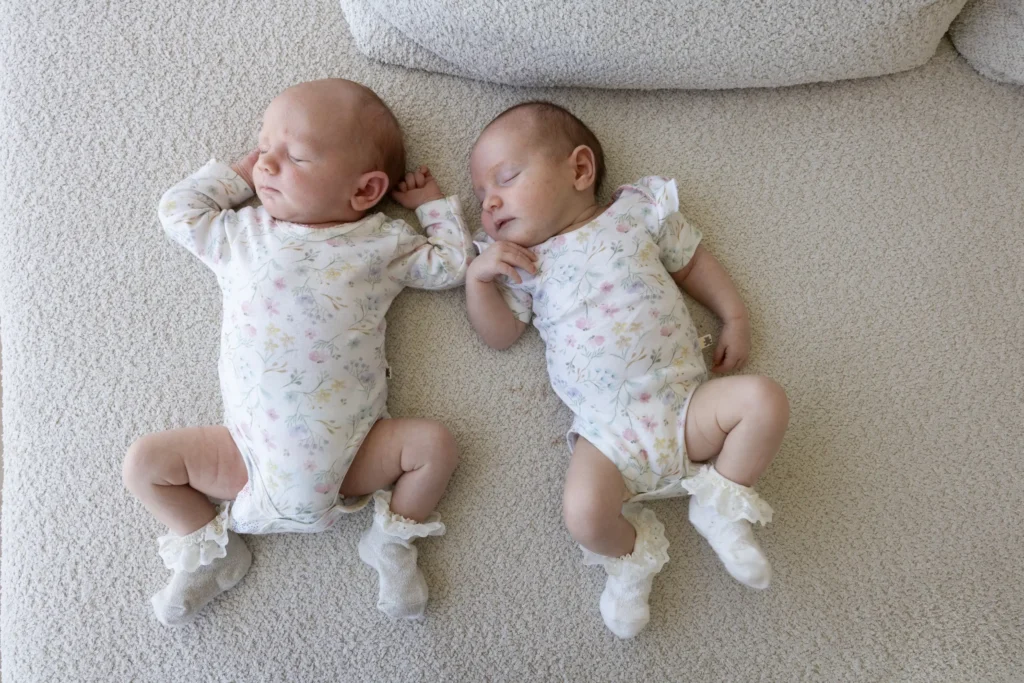 Identical twins defied incredible odds by welcoming baby girls on the exact same day in the same hospital - which also happened to be their own 32nd birthday.