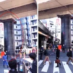 Commuters were left shocked when a huge 32ft steel pipe burst through a road from an underground construction site in Osaka, Japan - leaving a large crater in the street.