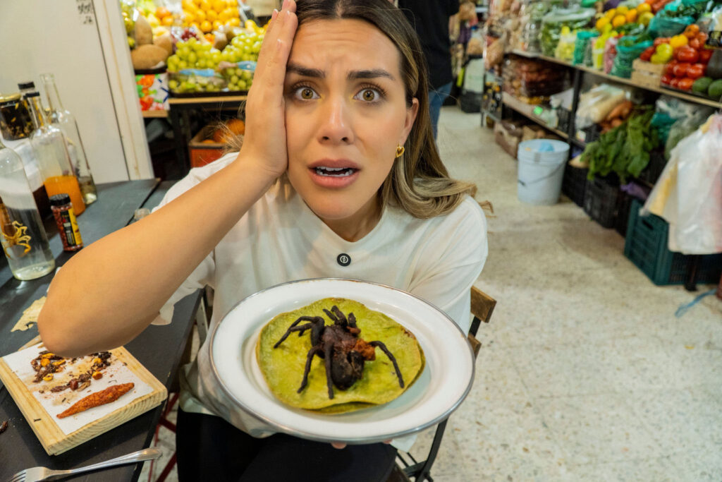 An influencer was left with prickly hairs stuck in her mouth after eating a tarantula taco at a Mexican market - saying the spider surprisingly tasted like pork scratchings.