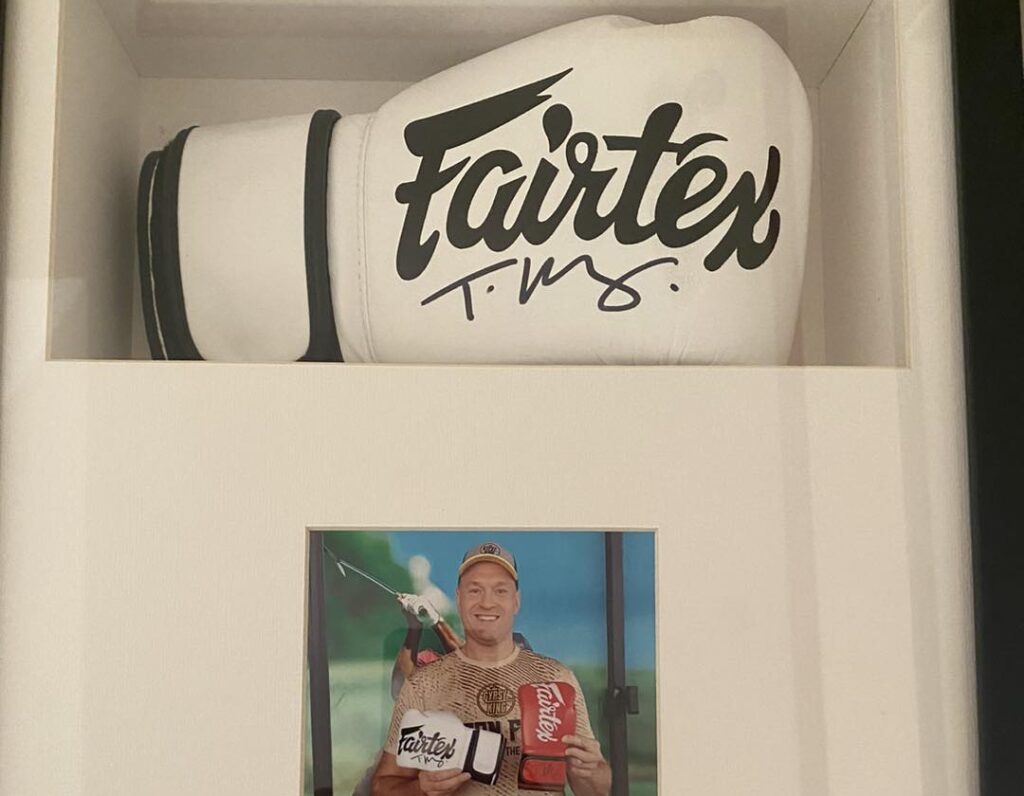 Signed gloves donated by Tyson Fury are set for a charity auction at a quirky Thailand pub, with proceeds supporting disadvantaged children at the Father Ray Foundation