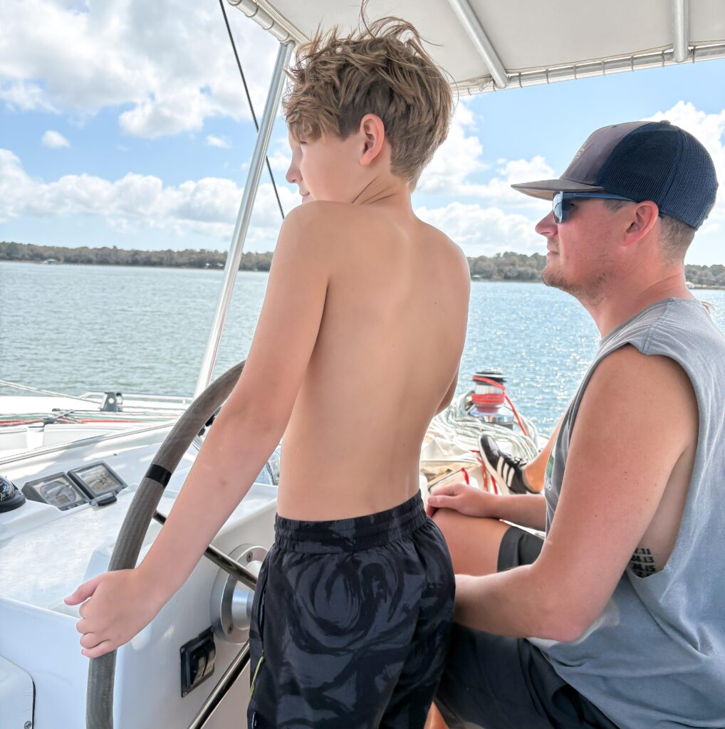 A couple sell their home to live on a catamaran with four kids, cutting bills by 75% while embracing a simpler life filled with travel, challenges and adventure.