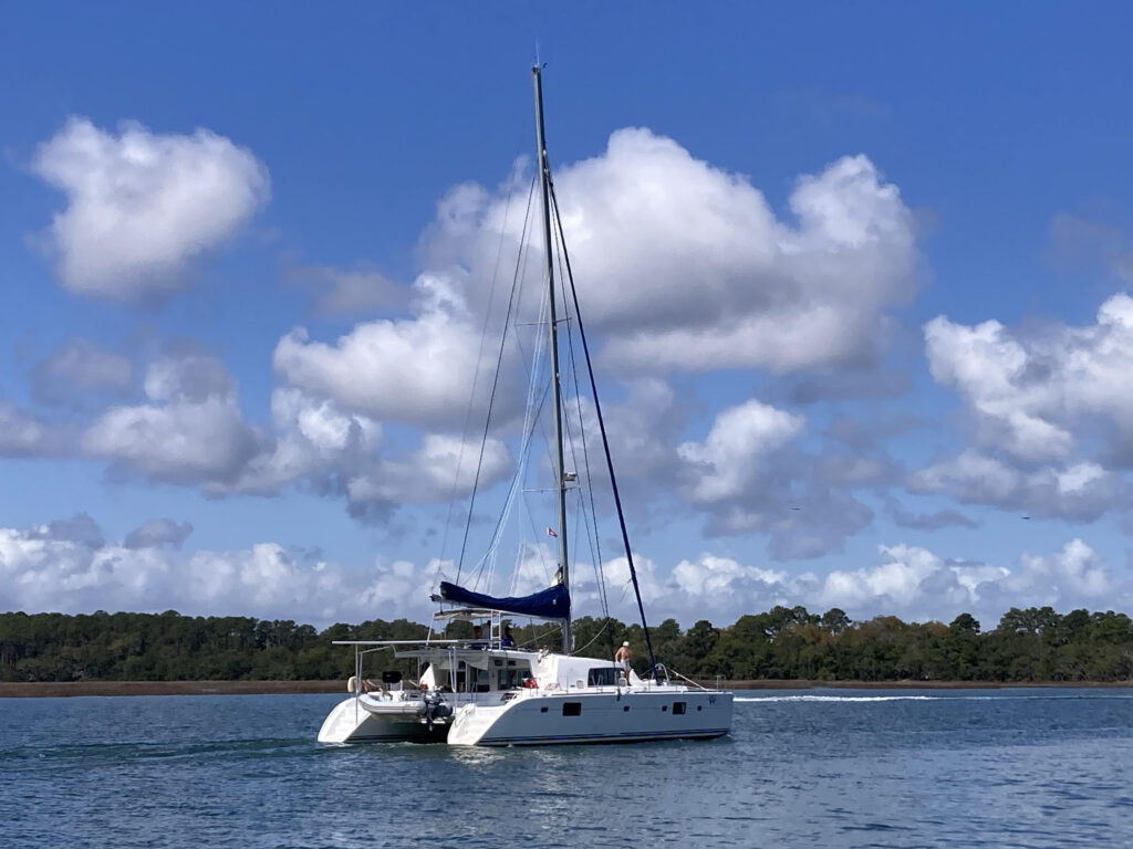A couple sell their home to live on a catamaran with four kids, cutting bills by 75% while embracing a simpler life filled with travel, challenges and adventure.