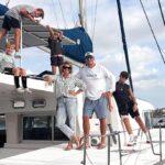 A couple sell their home to live on a catamaran with four kids, cutting bills by 75% while embracing a simpler life filled with travel, challenges and adventure.