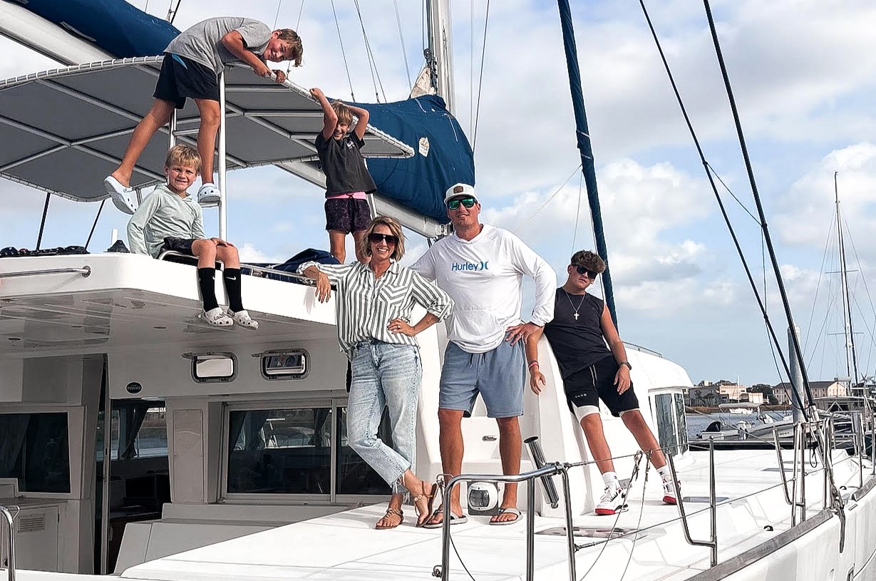 A couple sell their home to live on a catamaran with four kids, cutting bills by 75% while embracing a simpler life filled with travel, challenges and adventure.