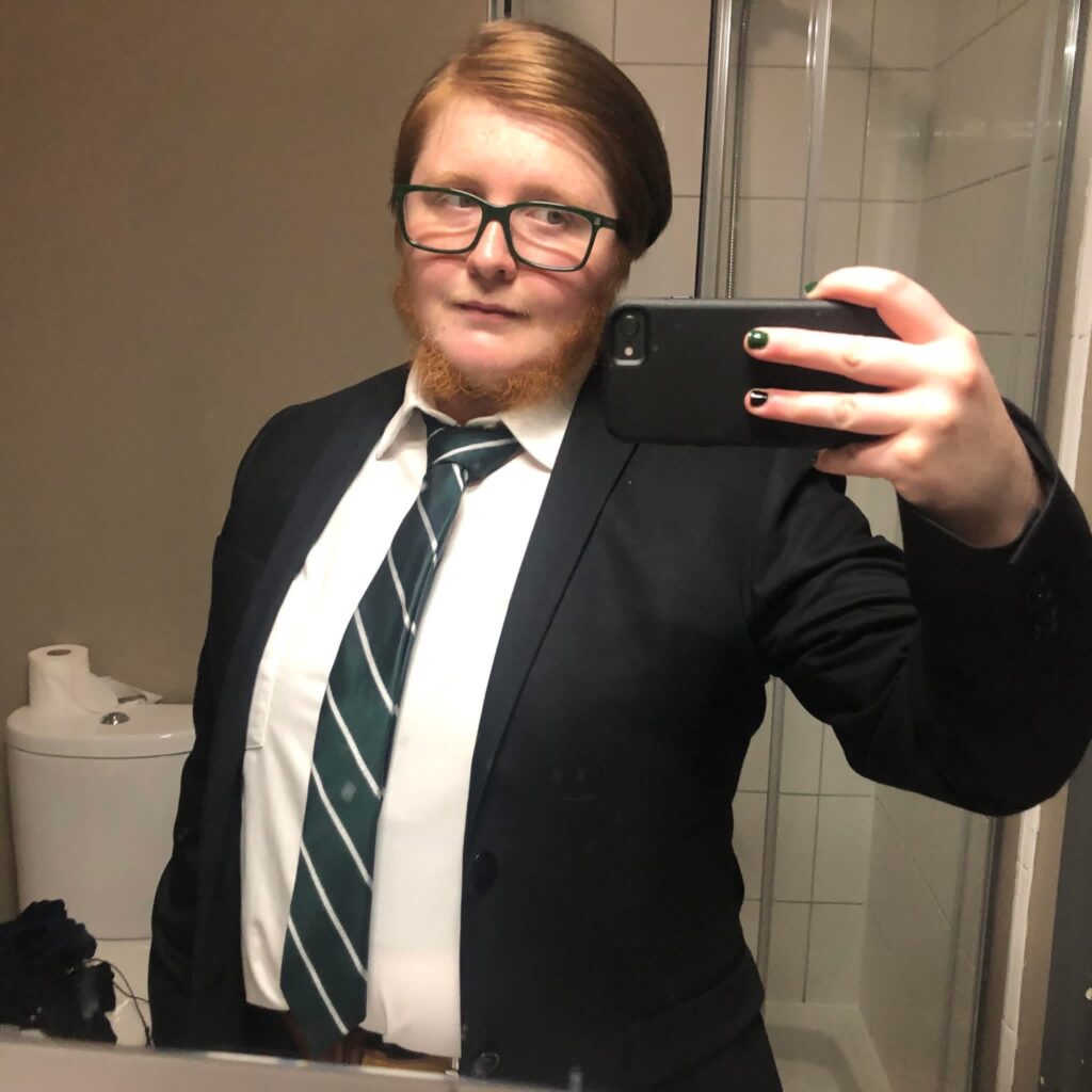 A woman with hirsutism proudly embraces her full neck beard despite cruel comments from strangers and exes who called it disgusting - saying she feels more beautiful and whole.