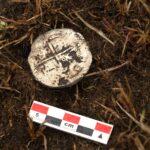 A 400-year-old silver coin unearthed near the Strait of Magellan has pinpointed the exact location of a doomed Spanish colony where most of 350 settlers perished within years.
