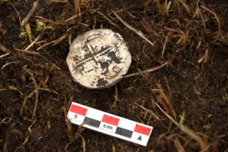 A 400-year-old silver coin unearthed near the Strait of Magellan has pinpointed the exact location of a doomed Spanish colony where most of 350 settlers perished within years.