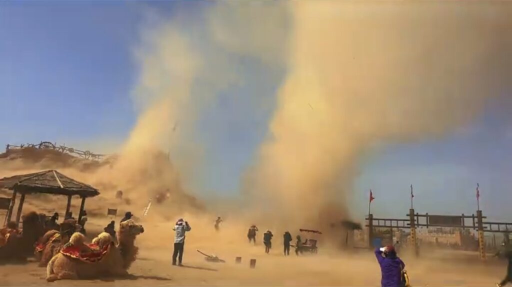 A dramatic dust devil sent visitors scrambling for cover as it tore through a famous Chinese Western film studio - but officials say it caused no damage and the park stayed open.