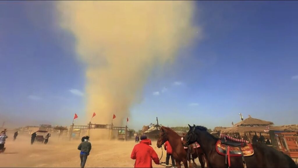 A dramatic dust devil sent visitors scrambling for cover as it tore through a famous Chinese Western film studio - but officials say it caused no damage and the park stayed open.