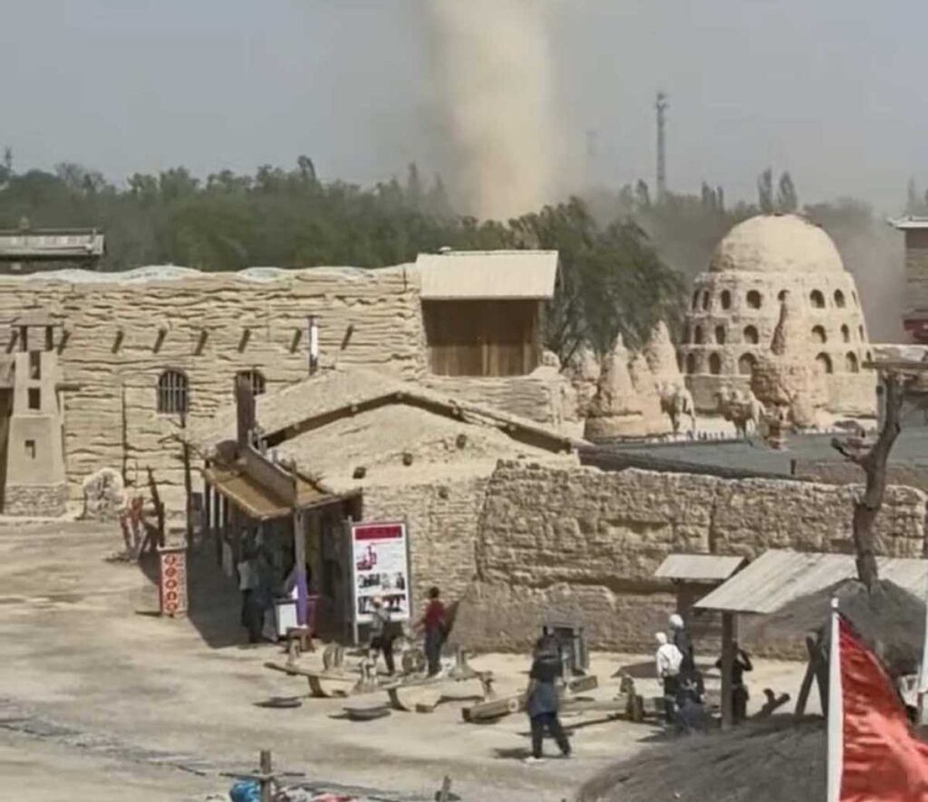 A dramatic dust devil sent visitors scrambling for cover as it tore through a famous Chinese Western film studio - but officials say it caused no damage and the park stayed open.