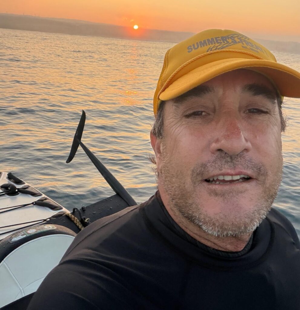 Stunned surfer films himself riding a massive wave with a huge 8ft hammerhead shark lurking just beneath him - and his face says it all when he spots the shadowy beast.