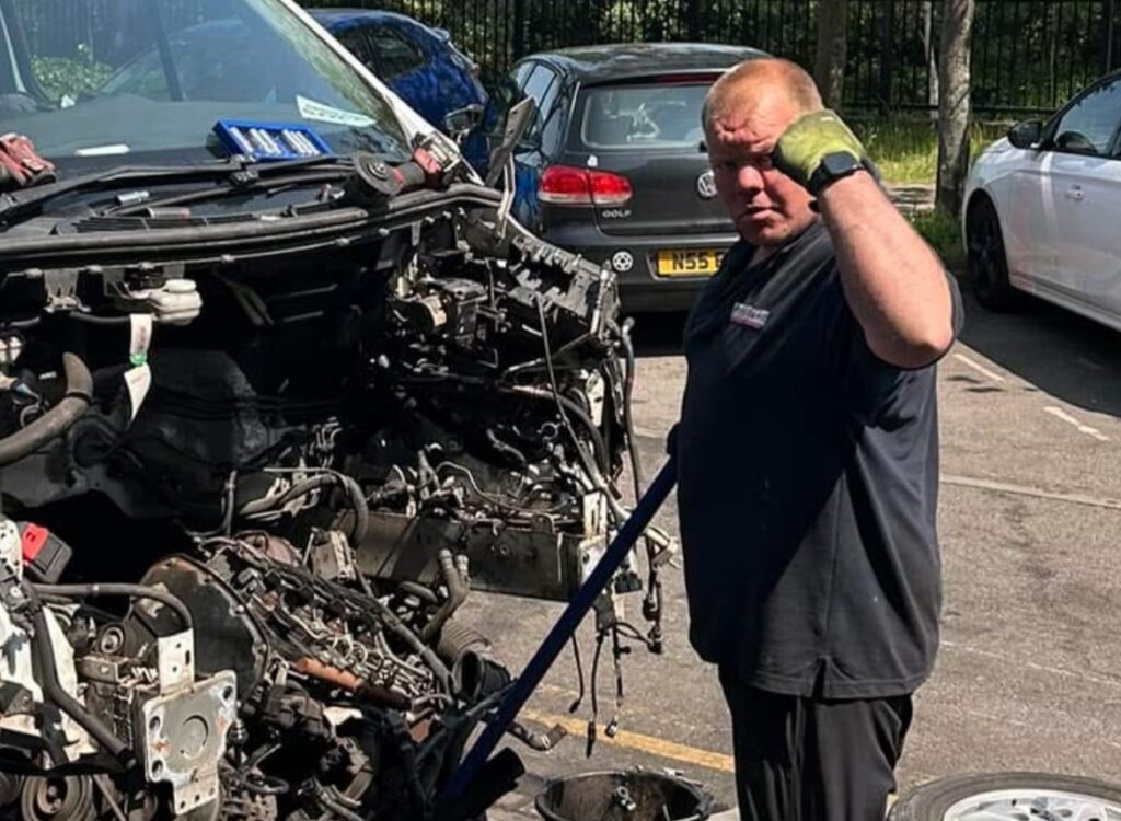 A worker cheats injury after a quad bike flips in a freak accident, performing a somersault while seated before walking away unharmed as stunned colleagues watch.