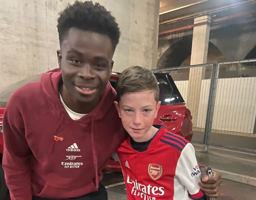 Bukayo Saka took a teenage fan's scarf during Arsenal's Champions League final celebrations, wrapping it around his neck and giving a thumbs up in a viral moment watched by millions.