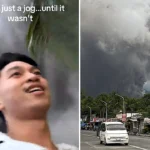 Terrifying moment joggers flee giant volcanic ash cloud near Mayon Volcano in Philippines - viral footage shows wall of black smoke racing toward them.