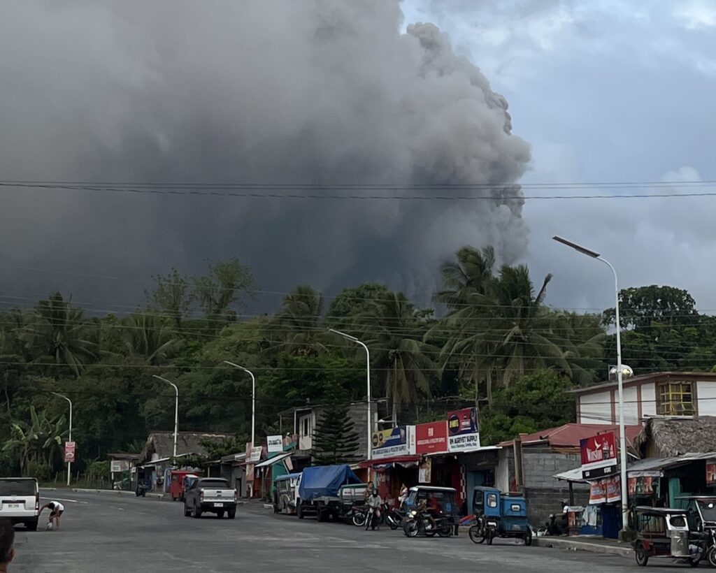 Terrifying moment joggers flee giant volcanic ash cloud near Mayon Volcano in Philippines - viral footage shows wall of black smoke racing toward them.